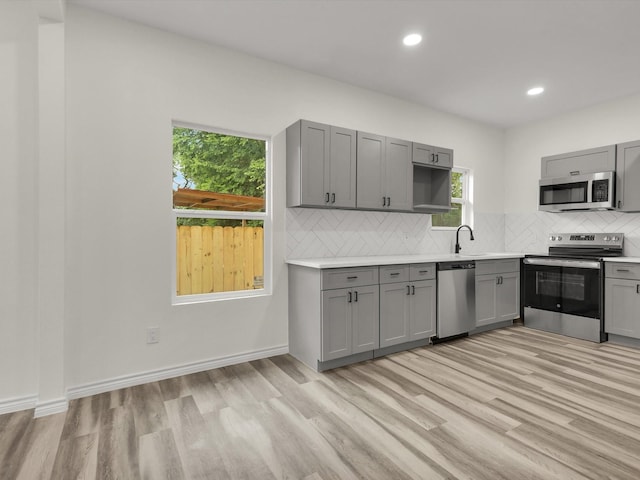 3526 Elsie Faye Heggins St, Dallas, TX 75210 - kitchen with stainless steel appliances, gray cabinets, light wood finished floors, light countertops, and recessed lighting