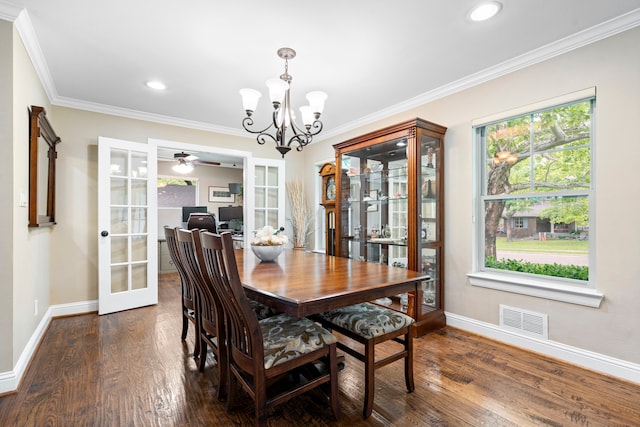 8928 Aldwick Cir, Dallas, TX 75238 - dining area with french doors, a chandelier, dark wood-style floors, healthy amount of natural light, and ornamental molding