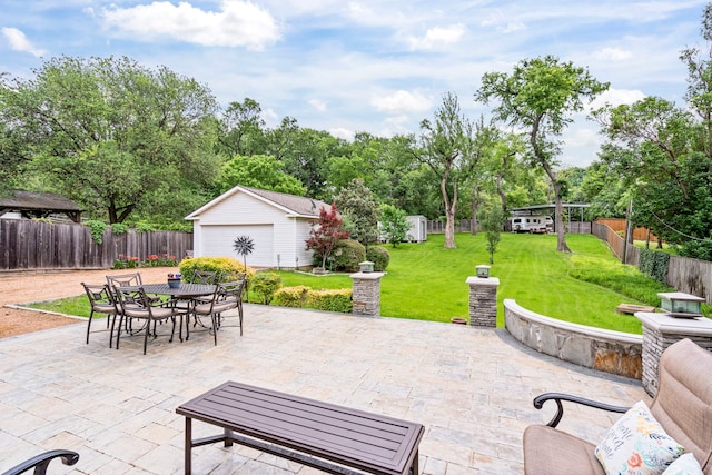 8928 Aldwick Cir, Dallas, TX 75238 - fenced backyard with an outbuilding, a patio, outdoor dining space, and a detached garage
