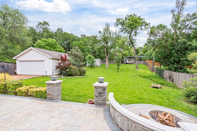 8928 Aldwick Cir, Dallas, TX 75238 - view of yard featuring an outdoor fire pit, an outbuilding, and a detached garage