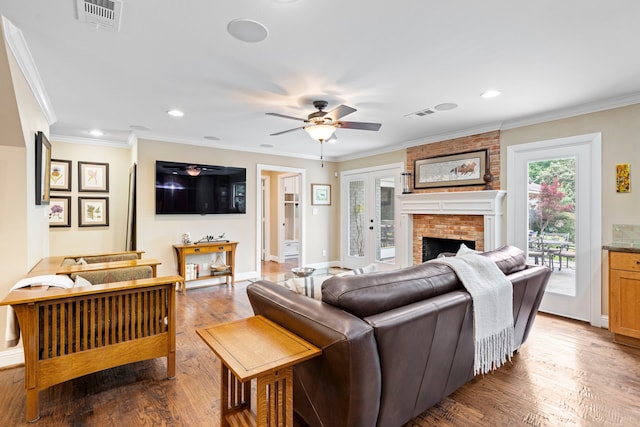 8928 Aldwick Cir, Dallas, TX 75238 - living room featuring a ceiling fan, a fireplace, wood finished floors, ornamental molding, and recessed lighting