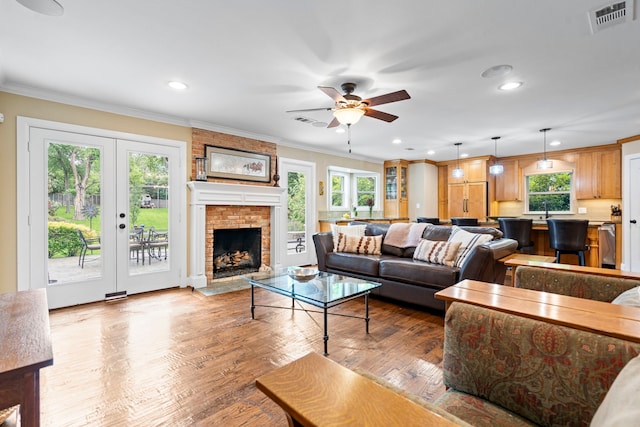 8928 Aldwick Cir, Dallas, TX 75238 - living area with plenty of natural light, french doors, ceiling fan, crown molding, and wood finished floors