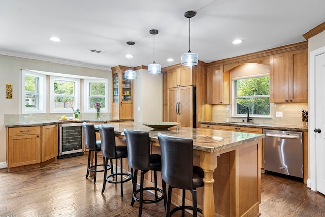 8928 Aldwick Cir, Dallas, TX 75238 - kitchen featuring stainless steel dishwasher, beverage cooler, paneled built in refrigerator, ornamental molding, and a center island