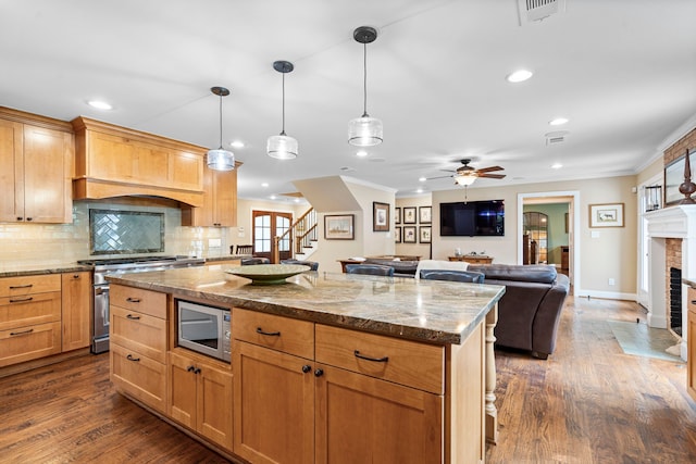 8928 Aldwick Cir, Dallas, TX 75238 - kitchen featuring stainless steel appliances, a brick fireplace, ornamental molding, premium range hood, and tasteful backsplash