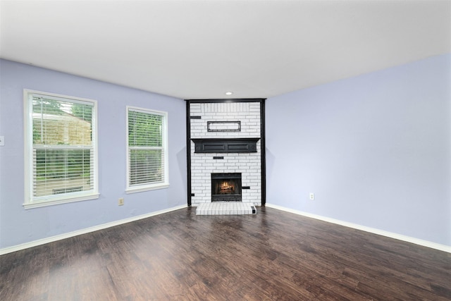 123 Austin Stone Dr, Duncanville, TX 75137 - unfurnished living room with a brick fireplace, wood finished floors, and recessed lighting