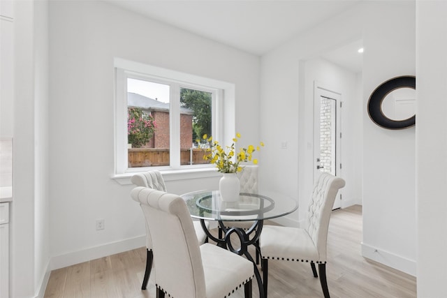 1000 W 10th St, Dallas, TX 75208 - dining area with light wood-style flooring and baseboards