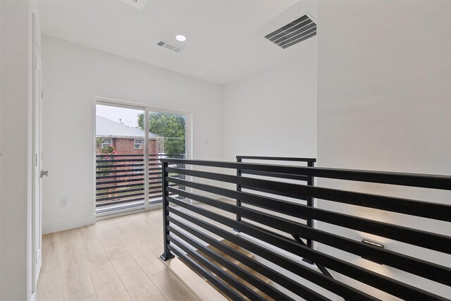 1000 W 10th St, Dallas, TX 75208 - hallway with an upstairs landing and light wood-style floors