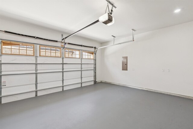 1000 W 10th St, Dallas, TX 75208 - garage featuring a garage door opener, electric panel, and recessed lighting