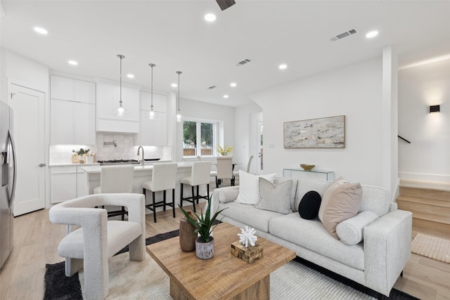1000 W 10th St, Dallas, TX 75208 - living room featuring recessed lighting, light wood finished floors, ceiling fan, and stairs