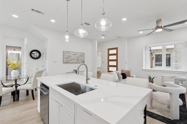 1000 W 10th St, Dallas, TX 75208 - kitchen with light wood finished floors, light stone countertops, decorative light fixtures, open floor plan, and recessed lighting