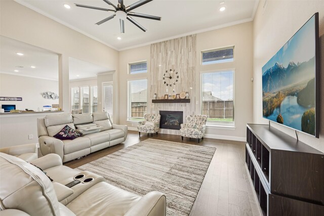 1330 Heavenly Pl, Wylie, TX 75098 - living area featuring a large fireplace, recessed lighting, wood finished floors, ceiling fan, and ornamental molding
