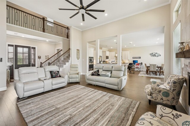 1330 Heavenly Pl, Wylie, TX 75098 - living room with ornamental molding, ceiling fan, wood finished floors, a high ceiling, and recessed lighting