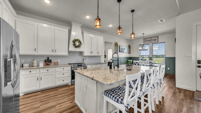 1401 County Road 1470, Chico, TX 76431 - kitchen featuring appliances with stainless steel finishes, white cabinets, custom range hood, backsplash, and recessed lighting