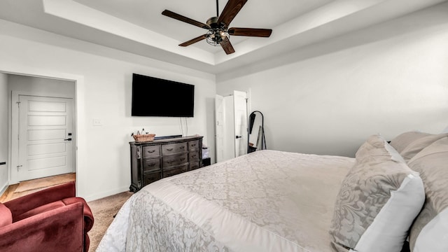 1401 County Road 1470, Chico, TX 76431 - bedroom with a tray ceiling, carpet, and a ceiling fan