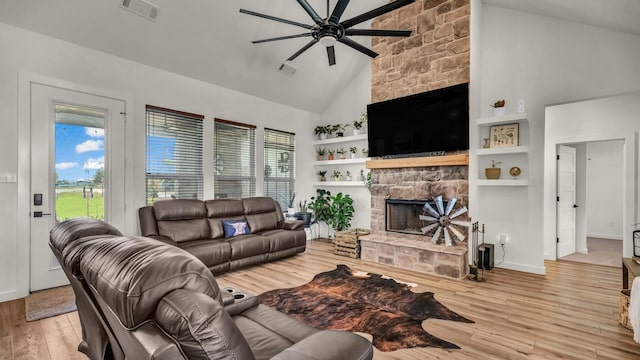 1401 County Road 1470, Chico, TX 76431 - living area with ceiling fan, high vaulted ceiling, a stone fireplace, wood finished floors, and healthy amount of natural light