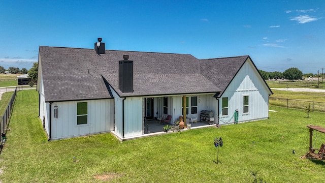 1401 County Road 1470, Chico, TX 76431 - back of house with a chimney, a patio area, a shingled roof, a fenced backyard, and board and batten siding