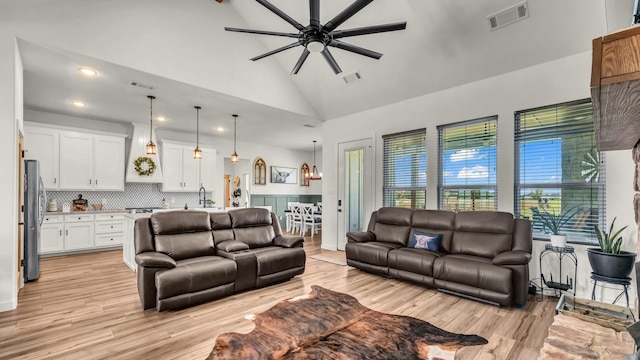 1401 County Road 1470, Chico, TX 76431 - living area featuring ceiling fan, light wood finished floors, recessed lighting, high vaulted ceiling, and a chandelier
