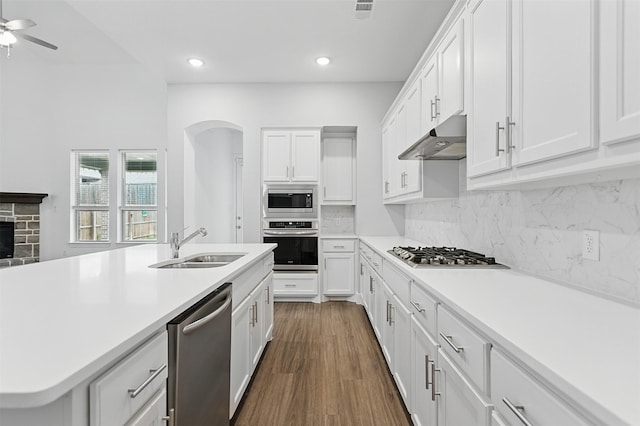 1519 Calcot Ln, Forney, TX 75126 - kitchen featuring stainless steel appliances, under cabinet range hood, white cabinets, light countertops, and dark wood-type flooring