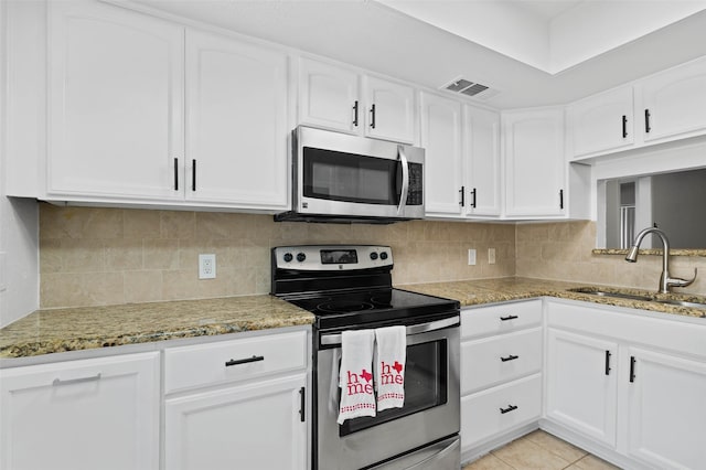 4555 N O Connor Rd Unit 2278, Irving, TX 75062 - kitchen featuring appliances with stainless steel finishes, white cabinets, and light stone counters