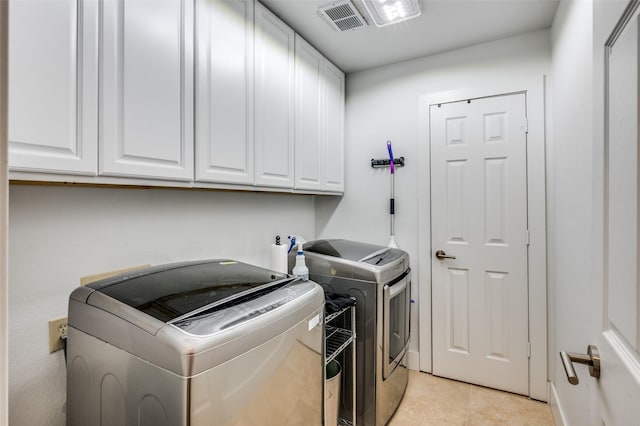 4320 Country Ln, Grapevine, TX 76051 - washroom with cabinet space, washer and clothes dryer, and light tile patterned floors