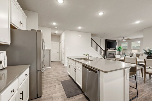 3018 Dakota Trl, Crandall, TX 75114 - kitchen featuring stainless steel appliances, a ceiling fan, a kitchen breakfast bar, white cabinetry, and recessed lighting