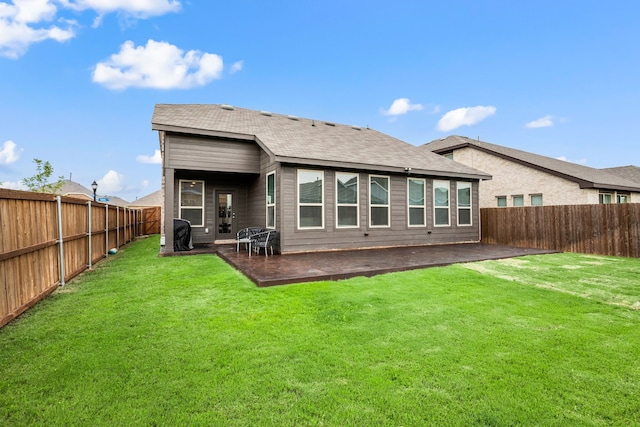 3018 Dakota Trl, Crandall, TX 75114 - back of property featuring a fenced backyard, a patio area, and a shingled roof