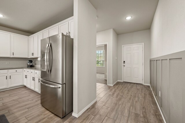 3018 Dakota Trl, Crandall, TX 75114 - kitchen with stainless steel refrigerator with ice dispenser, light wood-style floors, white cabinets, and recessed lighting