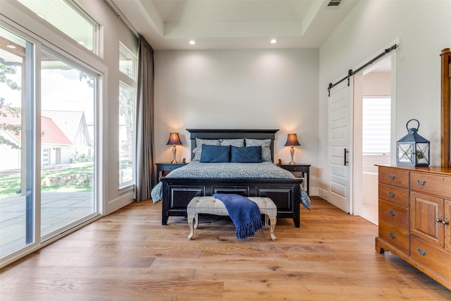 1757 Country Club Rd, Bowie, TX 76230 - bedroom with a barn door, access to exterior, recessed lighting, and light wood finished floors