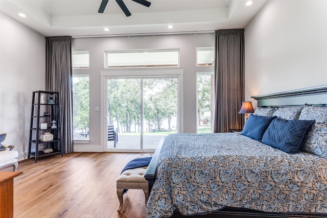 1757 Country Club Rd, Bowie, TX 76230 - bedroom featuring access to exterior, wood finished floors, recessed lighting, a tray ceiling, and a ceiling fan