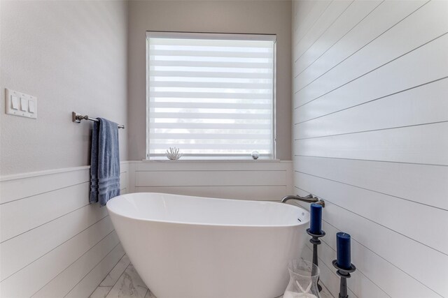 1757 Country Club Rd, Bowie, TX 76230 - full bath with a soaking tub, wood walls, and a wainscoted wall