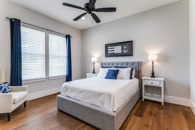1757 Country Club Rd, Bowie, TX 76230 - bedroom featuring wood finished floors, multiple windows, and a ceiling fan
