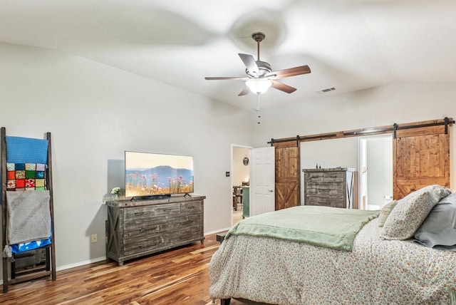 1323 Canyon Creek Rd, Wylie, TX 75098 - bedroom featuring a barn door, wood finished floors, vaulted ceiling, and ceiling fan