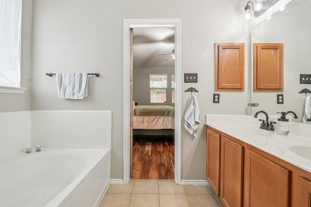 1323 Canyon Creek Rd, Wylie, TX 75098 - ensuite bathroom featuring a bath, double vanity, a ceiling fan, and tile patterned floors