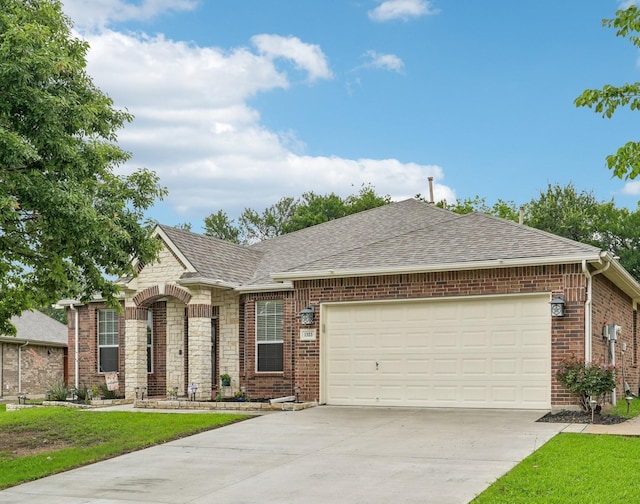 1323 Canyon Creek Rd, Wylie, TX 75098 - view of front of house featuring concrete driveway, a shingled roof, a garage, a front lawn, and brick siding