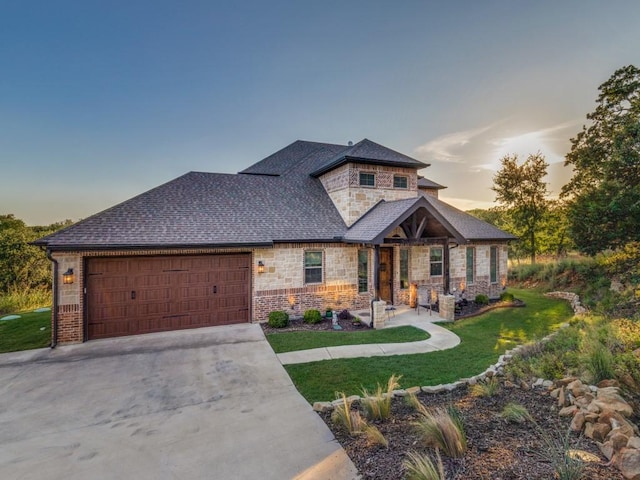 165 Cote D Azur, Chico, TX 76431 - view of front of property featuring stone siding, an attached garage, a front lawn, and concrete driveway