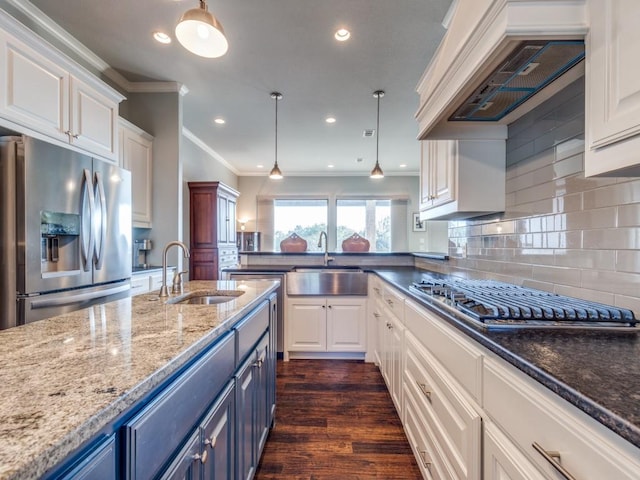 165 Cote D Azur, Chico, TX 76431 - kitchen with appliances with stainless steel finishes, blue cabinetry, crown molding, white cabinets, and premium range hood