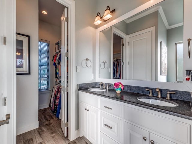 165 Cote D Azur, Chico, TX 76431 - bathroom featuring double vanity, a spacious closet, crown molding, and wood finished floors