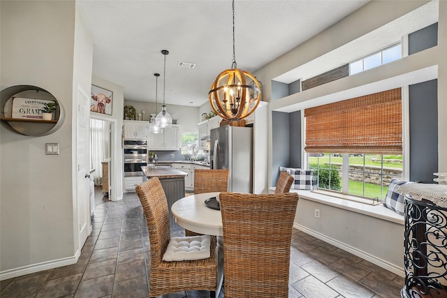 7104 Harlan Dr, Rockwall, TX 75087 - dining room with baseboards and a chandelier