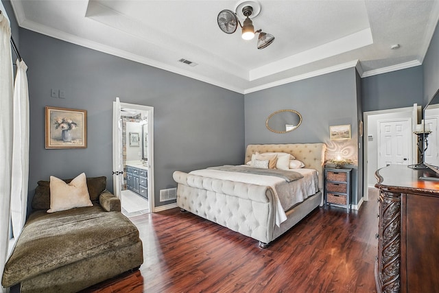 7104 Harlan Dr, Rockwall, TX 75087 - bedroom featuring a raised ceiling, dark wood-style floors, ornamental molding, and ensuite bath