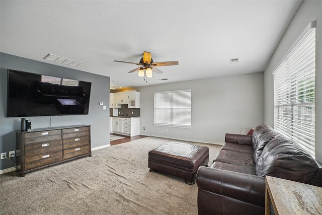 7104 Harlan Dr, Rockwall, TX 75087 - living room featuring carpet flooring and a ceiling fan