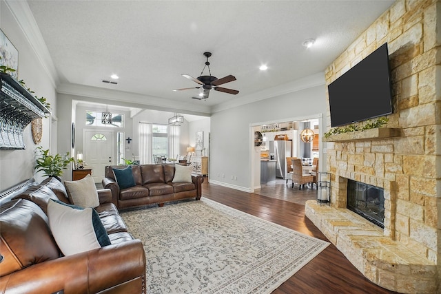 7104 Harlan Dr, Rockwall, TX 75087 - living area with a ceiling fan, wood finished floors, crown molding, recessed lighting, and a stone fireplace