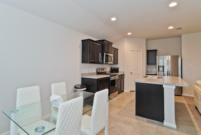 941 Loomis Trl, Justin, TX 76247 - kitchen with appliances with stainless steel finishes, light countertops, recessed lighting, an island with sink, and vaulted ceiling
