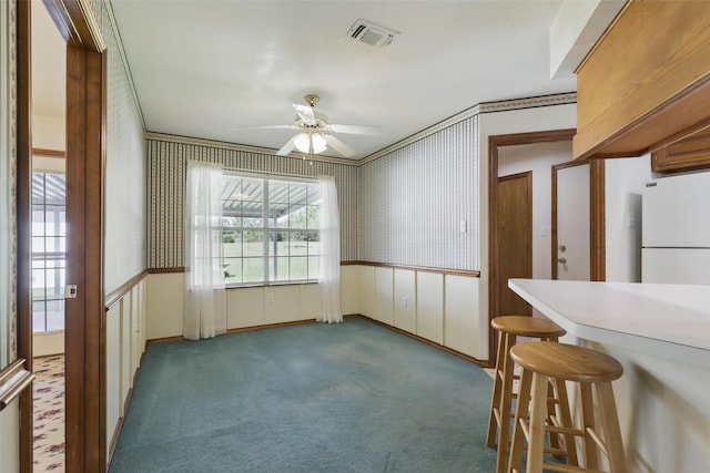4018 Oakview Cir, Alvarado, TX 76009 - unfurnished dining area featuring a ceiling fan, carpet floors, and wallpapered walls