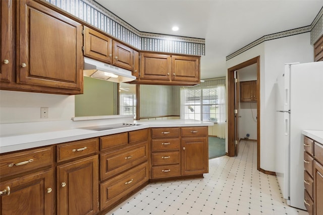 4018 Oakview Cir, Alvarado, TX 76009 - kitchen featuring under cabinet range hood, freestanding refrigerator, black electric stovetop, light countertops, and brown cabinets