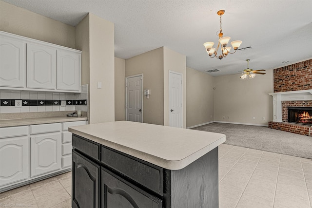 796 Oak Hollow Ln, Rockwall, TX 75087 - kitchen featuring a ceiling fan, a chandelier, white cabinetry, light carpet, and light countertops