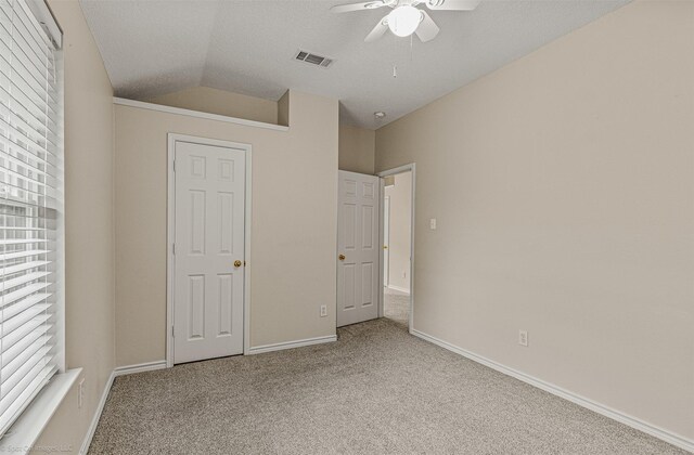 796 Oak Hollow Ln, Rockwall, TX 75087 - unfurnished bedroom with carpet floors, vaulted ceiling, and a ceiling fan