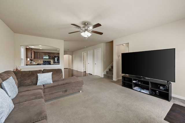 6524 Sheridan Cir, Arlington, TX 76017 - carpeted living area featuring arched walkways, a ceiling fan, and stairway