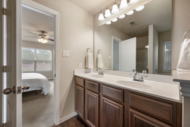 6524 Sheridan Cir, Arlington, TX 76017 - full bath with double vanity, wood finished floors, a ceiling fan, and connected bathroom