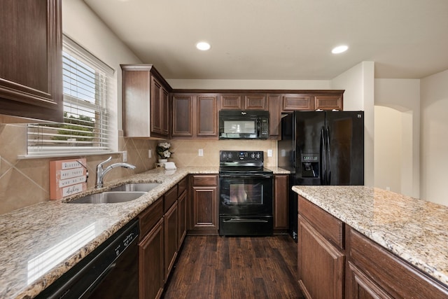 6524 Sheridan Cir, Arlington, TX 76017 - kitchen featuring black appliances, dark wood-style flooring, decorative backsplash, light stone counters, and dark brown cabinets