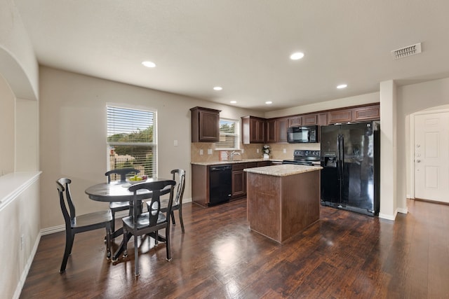 6524 Sheridan Cir, Arlington, TX 76017 - kitchen with black appliances, dark brown cabinets, a center island, decorative backsplash, and dark wood-type flooring